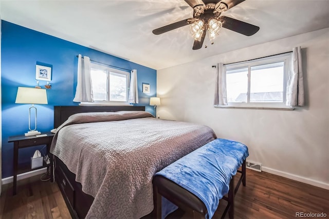 bedroom with ceiling fan and dark wood-type flooring