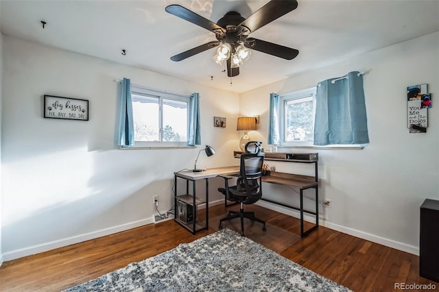 office area with dark wood-type flooring and ceiling fan