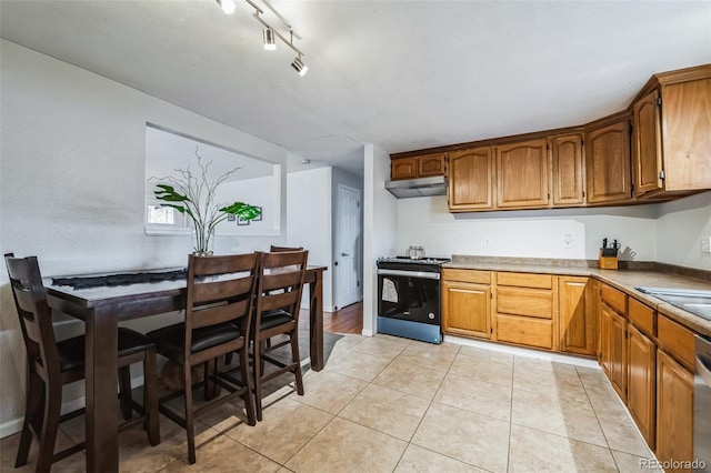 kitchen featuring dishwasher, light tile patterned flooring, rail lighting, and black range