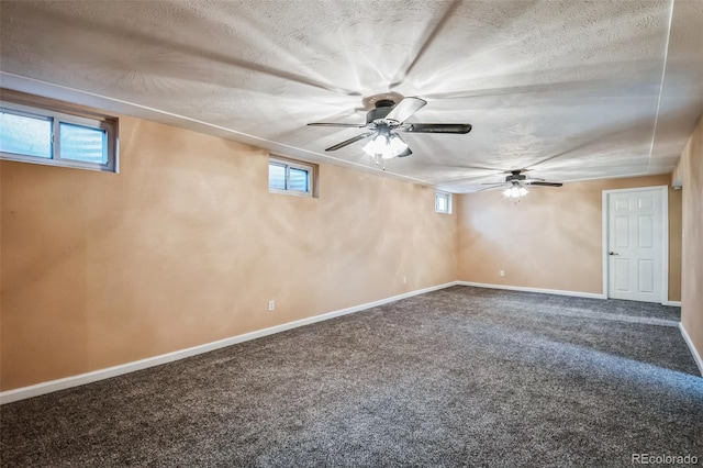 basement with a textured ceiling, a healthy amount of sunlight, and carpet