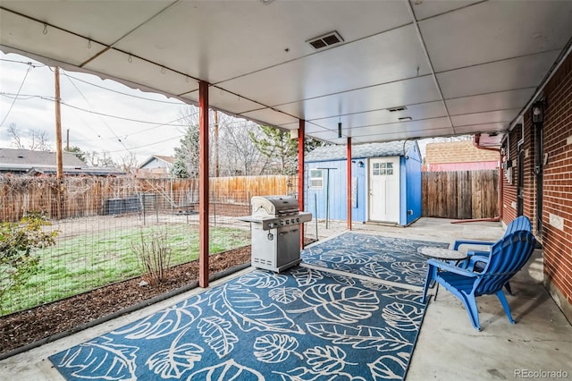 view of patio / terrace featuring area for grilling and a storage shed