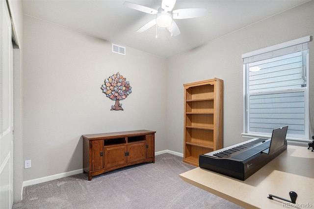 carpeted office featuring ceiling fan