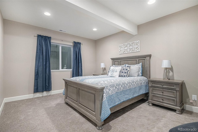 bedroom with beam ceiling and light colored carpet