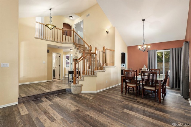 dining area with a notable chandelier, dark hardwood / wood-style floors, and high vaulted ceiling