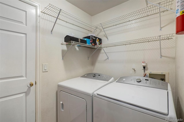 clothes washing area with separate washer and dryer