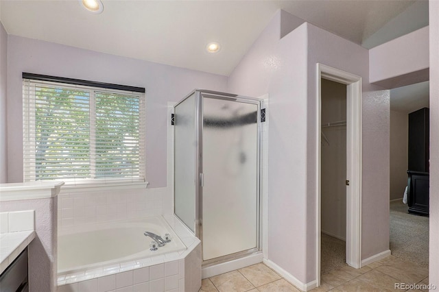 bathroom featuring vanity, plus walk in shower, and tile patterned floors