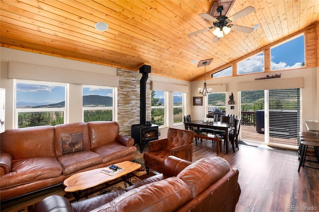 1301 Sheep Ridge Rd, Fairplay, CO 80440 - living area featuring wood ceiling, a wood stove, dark wood-type flooring, a ceiling fan, and a chandelier