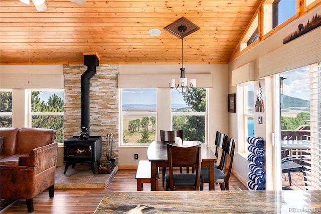1301 Sheep Ridge Rd, Fairplay, CO 80440 - dining area featuring a wood stove, wood ceiling, wood finished floors, and vaulted ceiling