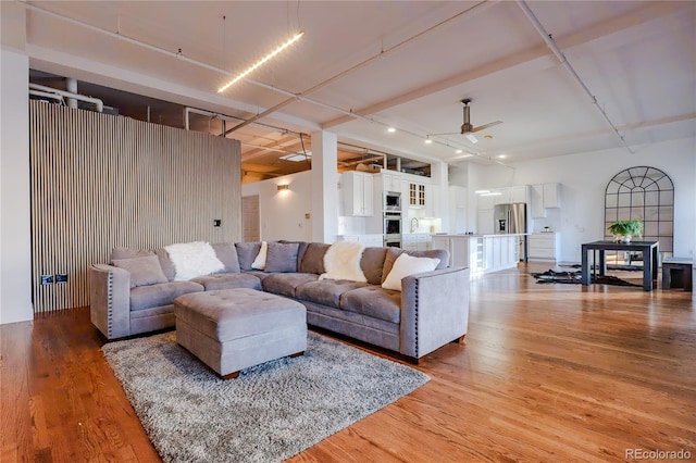 1555 California St Unit 605, Denver, CO 80202 - living room with a ceiling fan and light wood-style flooring