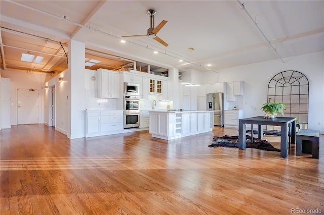 1555 California St Unit 605, Denver, CO 80202 - living room with a ceiling fan, light wood-style flooring, recessed lighting, and baseboards