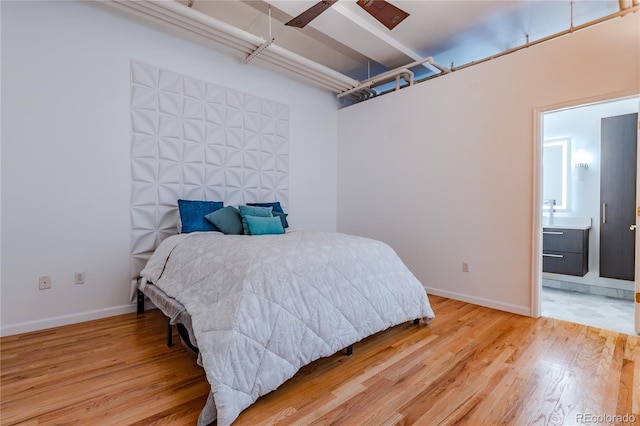 1555 California St Unit 605, Denver, CO 80202 - bedroom with light wood-type flooring, baseboards, and ensuite bathroom