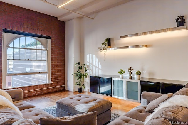 1555 California St Unit 605, Denver, CO 80202 - living area with brick wall and wood finished floors