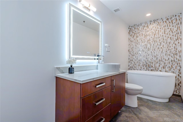 1555 California St Unit 605, Denver, CO 80202 - bathroom with tile walls, a soaking tub, vanity, toilet, and stone finish floors