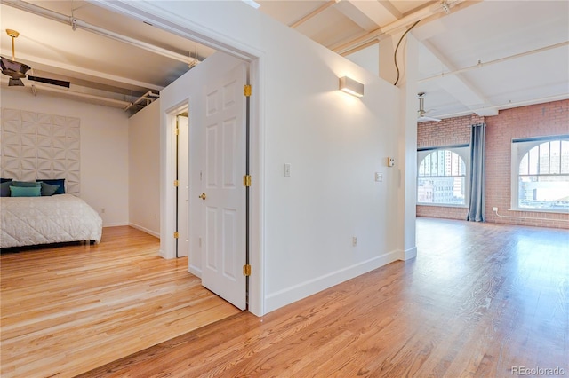 1555 California St Unit 605, Denver, CO 80202 - corridor with brick wall, wood finished floors, beam ceiling, and baseboards