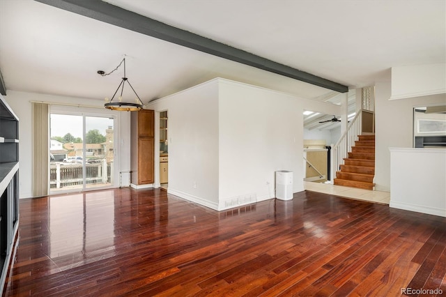 7210 Otis Ct, Arvada, CO 80003 - unfurnished living room featuring wood finished floors, stairway, and a chandelier