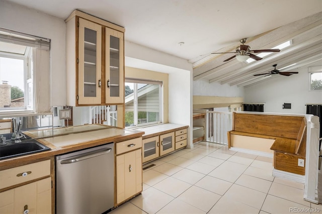 7210 Otis Ct, Arvada, CO 80003 - kitchen with stainless steel dishwasher, a ceiling fan, light tile patterned floors, glass insert cabinets, and tile countertops