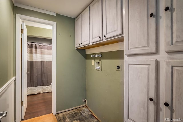 7210 Otis Ct, Arvada, CO 80003 - laundry room featuring electric dryer hookup, washer hookup, cabinet space, and light wood-type flooring