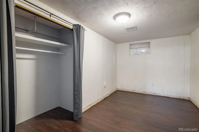 7210 Otis Ct, Arvada, CO 80003 - unfurnished bedroom featuring dark wood-style floors, a textured ceiling, and a closet