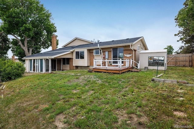 7210 Otis Ct, Arvada, CO 80003 - rear view of house featuring a deck, a chimney, brick siding, and a sunroom