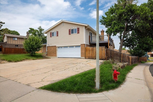 7210 Otis Ct, Arvada, CO 80003 - view of front facade with a garage, brick siding, and concrete driveway
