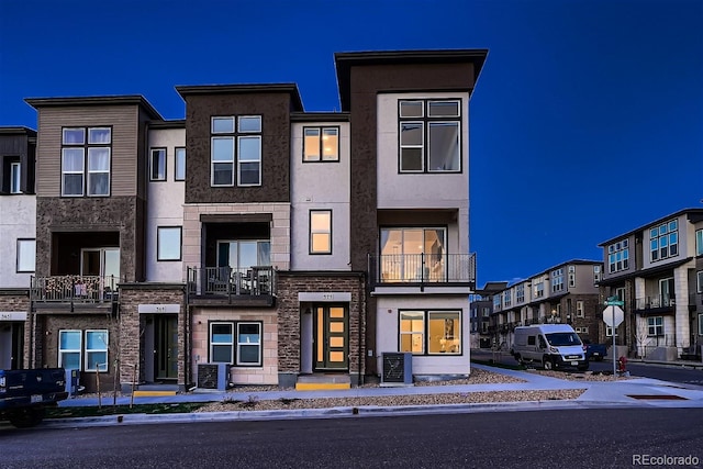 townhome / multi-family property with central AC and stucco siding