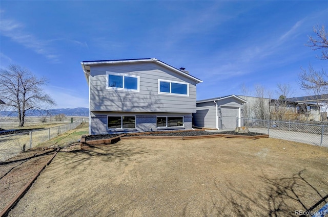 view of front facade featuring brick siding, concrete driveway, an attached garage, and fence