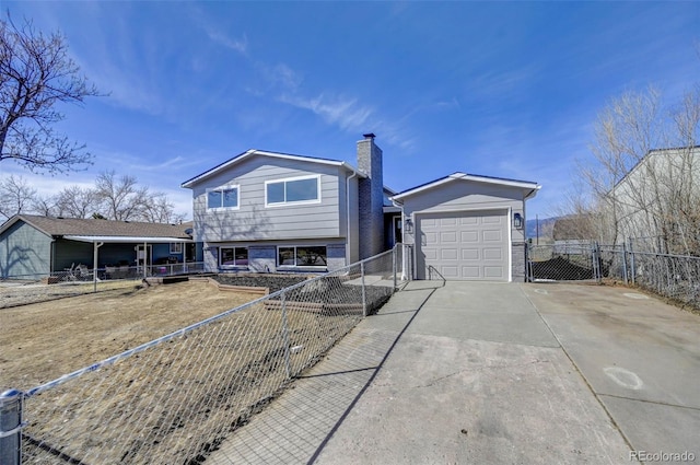 view of front of property with an attached garage, fence, a chimney, driveway, and a gate