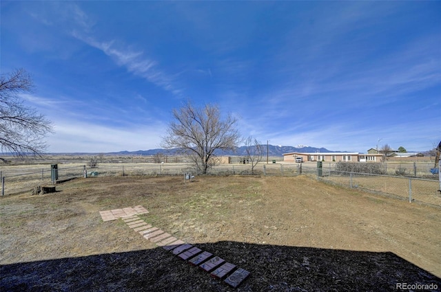 view of yard featuring a rural view and fence