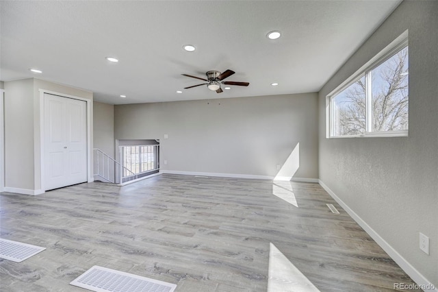 unfurnished room featuring ceiling fan, baseboards, wood finished floors, and recessed lighting