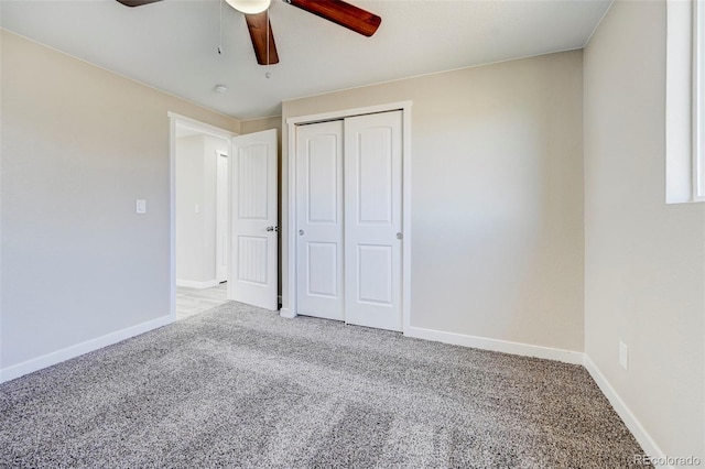 unfurnished bedroom with a closet, ceiling fan, baseboards, and carpet