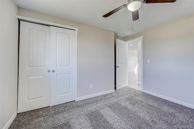 unfurnished bedroom with a closet, carpet flooring, a ceiling fan, and baseboards