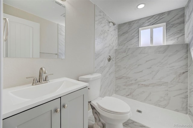 full bathroom featuring vanity, visible vents, tiled shower, toilet, and marble finish floor