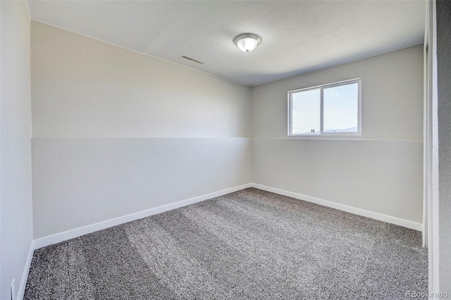 unfurnished room with visible vents, carpet flooring, and baseboards