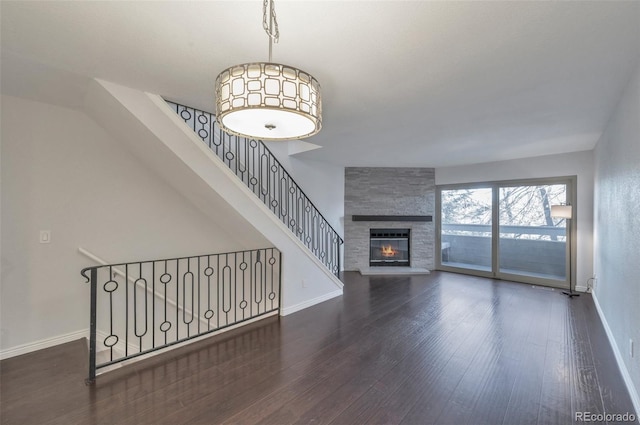 living room featuring dark hardwood / wood-style flooring and a fireplace