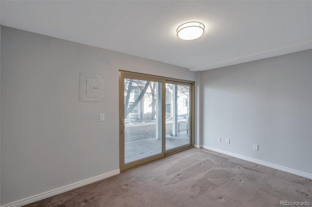 carpeted empty room with a textured ceiling