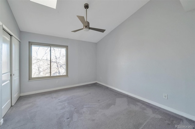 unfurnished bedroom with ceiling fan, lofted ceiling, carpet floors, and a closet