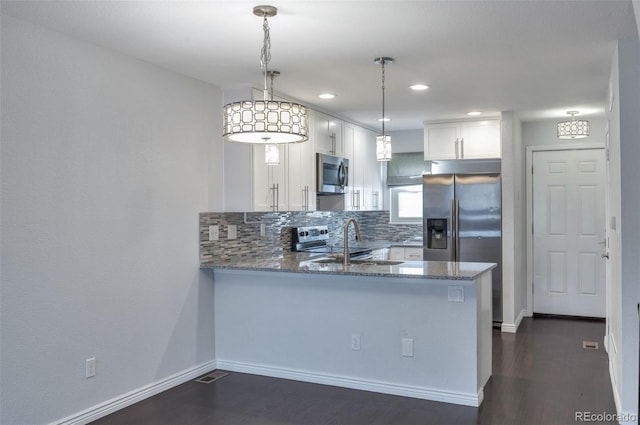 kitchen with pendant lighting, white cabinetry, sink, kitchen peninsula, and stainless steel appliances