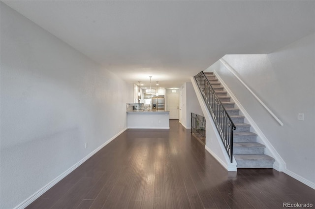 unfurnished living room featuring dark hardwood / wood-style floors