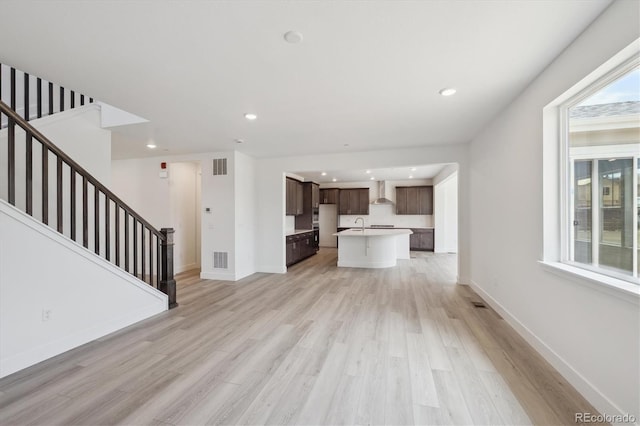 1376 Lumber Ridge Cir N, Erie, CO 80516 - unfurnished living room featuring light wood finished floors, plenty of natural light, stairs, and recessed lighting