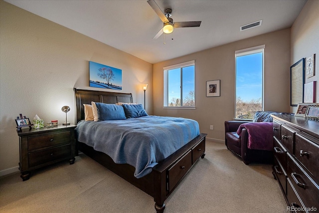 bedroom featuring light colored carpet and ceiling fan