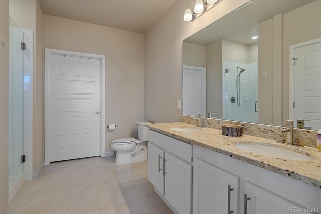 bathroom with vanity, toilet, a shower with shower door, and tile patterned flooring