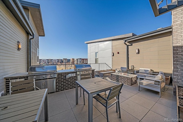 view of patio / terrace featuring area for grilling, exterior kitchen, and a fire pit