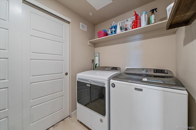 420 E Fremont Pl Unit 203, Centennial, CO 80122 - washroom with washer and clothes dryer and light tile patterned floors