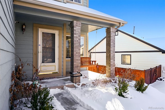 view of snow covered property entrance