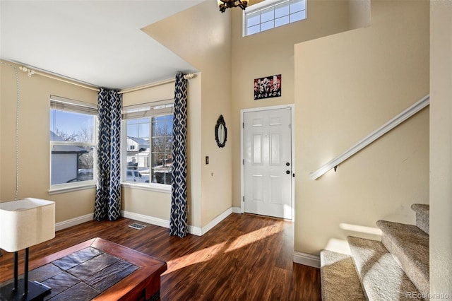 entrance foyer with a high ceiling and dark hardwood / wood-style floors