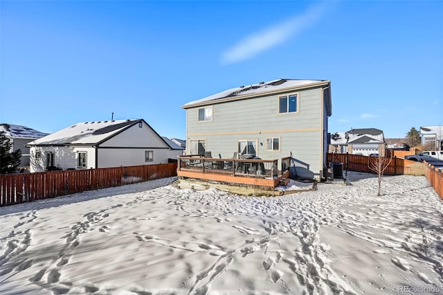 snow covered back of property featuring a deck and central air condition unit