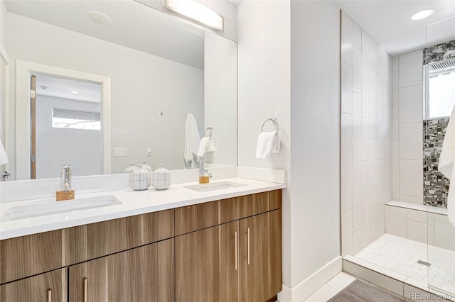 bathroom featuring vanity and tiled shower