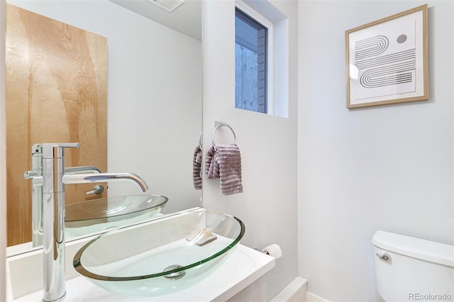 bathroom featuring vanity and toilet