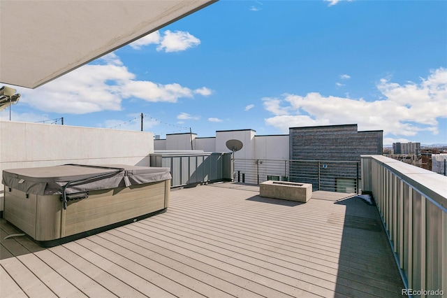 wooden deck with a hot tub