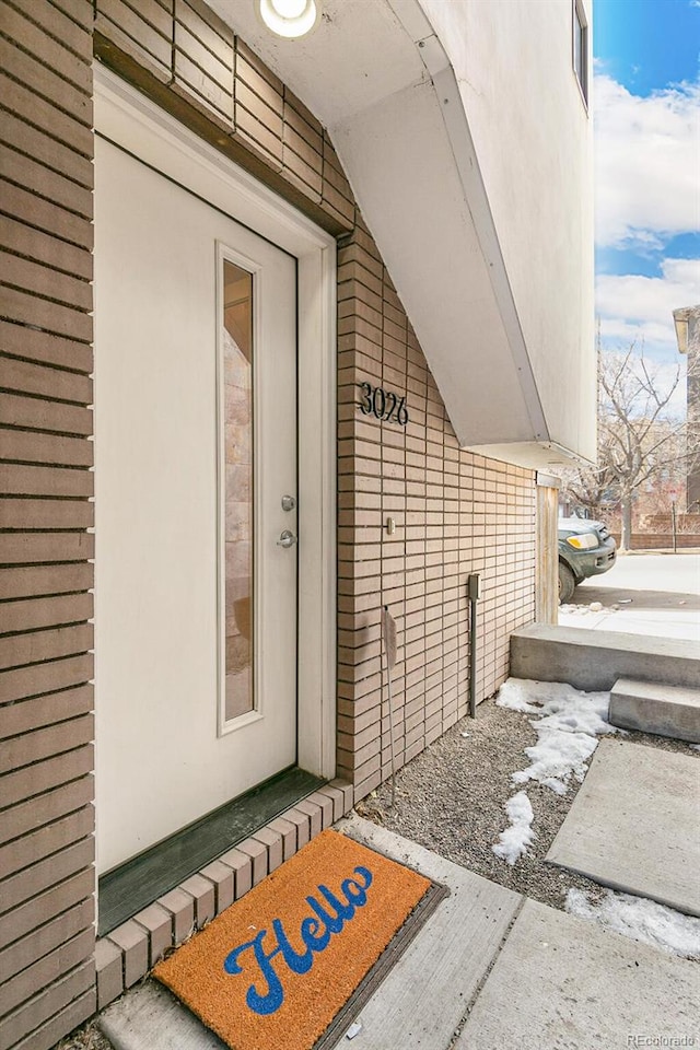 view of snow covered property entrance